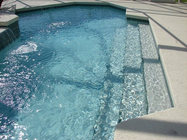 A concrete pool in a backyard in Aurora CO. 